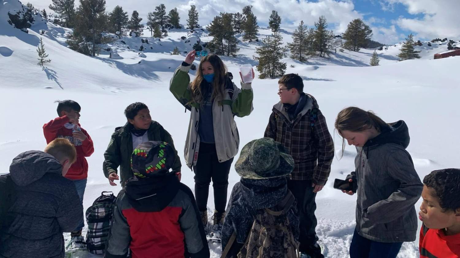 Teacher outdoors in the snow with students