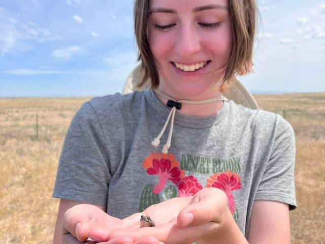 Abella Cathey holding a spadefoot toad.