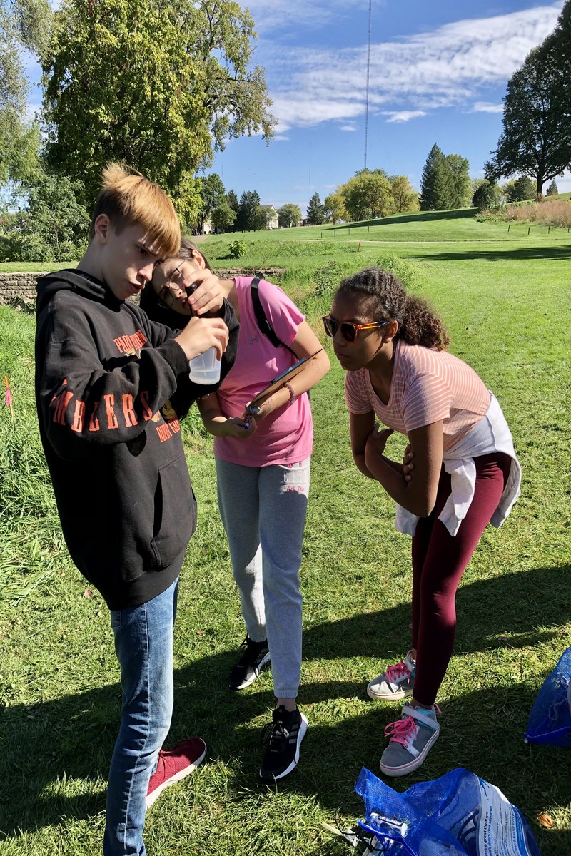 students from Iowa collect water samples in the field