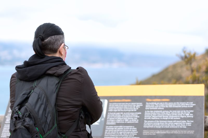 person reading signage at national park
