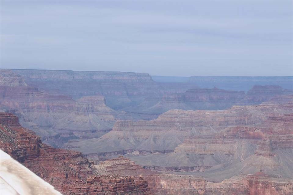 An overlook of Grand Canyon National Park. Hazy air from nearby wildfires has significantly lowered visibility in the area.