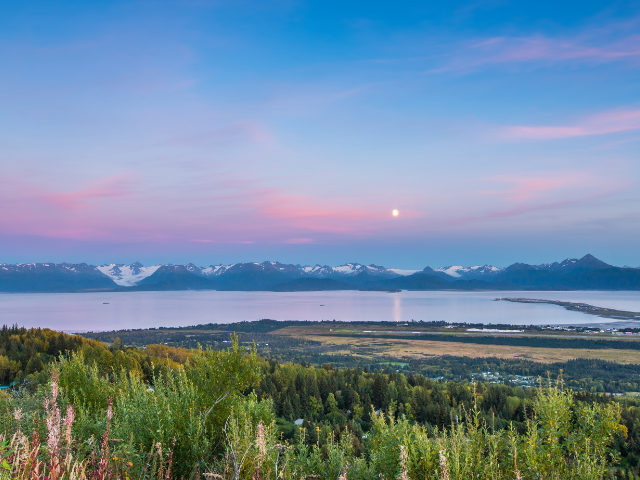 Sunset over Kachemak Bay with the mountains of Alaska in the background.