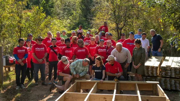Toyota employee volunteers, NEEF Staff and Land Trust staff stand together near boardwalk construction on National Public Lands Day