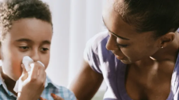 mother caring for son with stuffy nose
