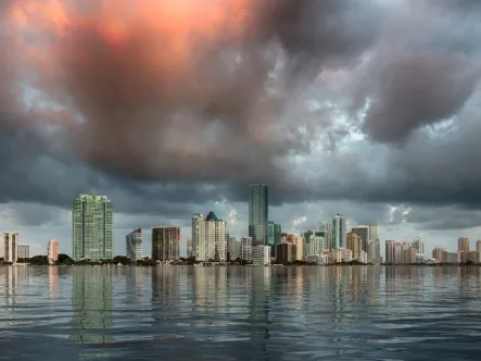 Photo of Miami at sunrise reflecting in the water, adapting to climate change