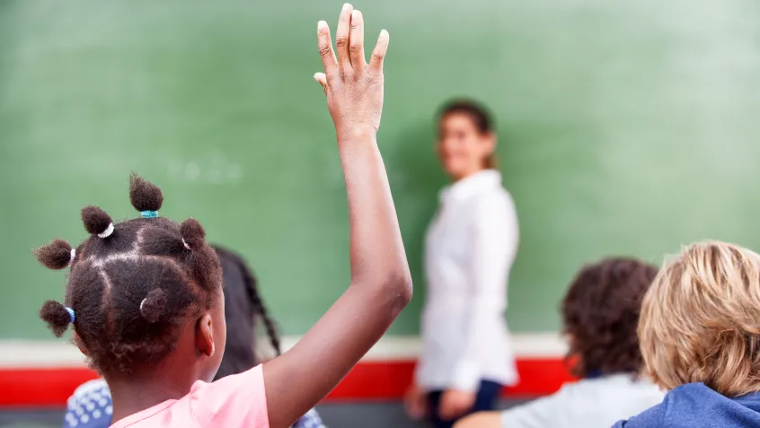 Student raising hand in class