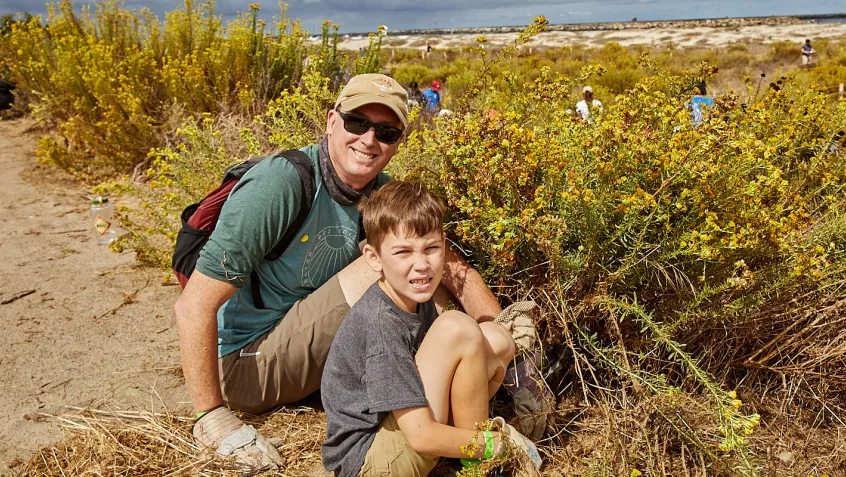 Dad and son planting at San Diego River Mouth
