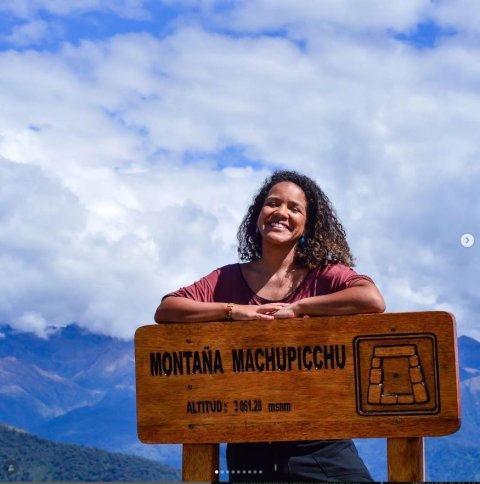 a woman poses near a Montana Machupicchiu