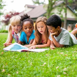 Students reading in a school yard outside