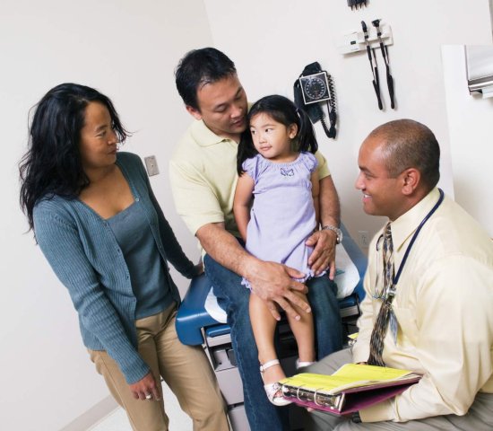 Doctor with parents and young child