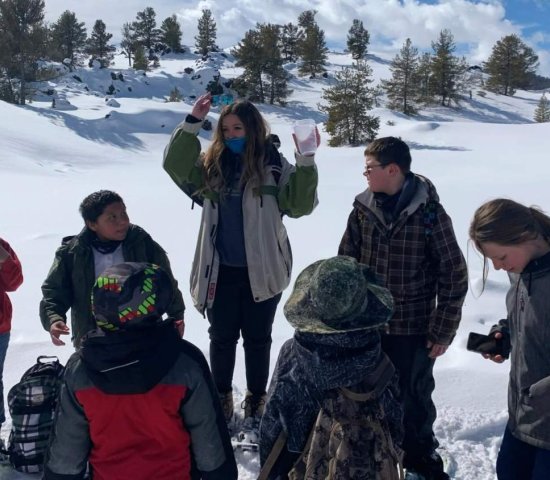 Teacher outdoors in the snow with students