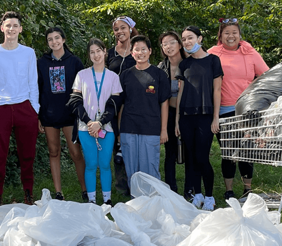 youth volunteers on standing with filled garbage bags on National Public Lands Day