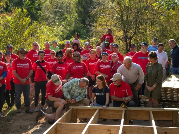 Toyota employee volunteers, NEEF Staff and Land Trust staff stand together near boardwalk construction on National Public Lands Day