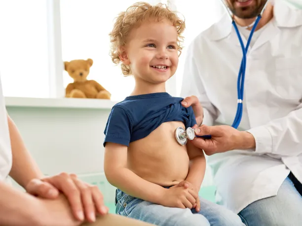 Doctor with stethoscope on child's chest 