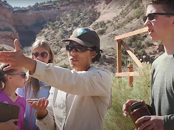 A BLM scientist instructs a group of students during an environmental education lesson in Colorado Canyon