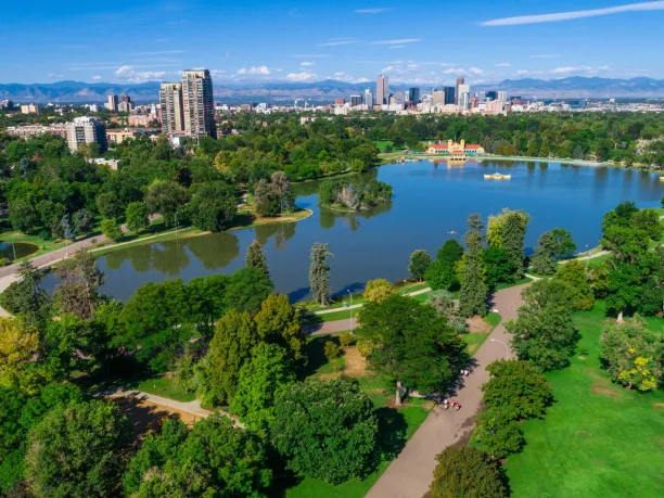 a city park in Denver with skyline and mountains in the background