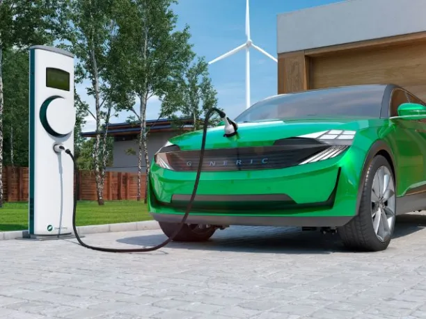 an image of a generic electric car with charging station and wind turbine in the background