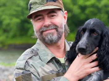 Veteran with his dog outdoors