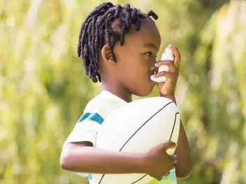 Child using an inhaler outdoors